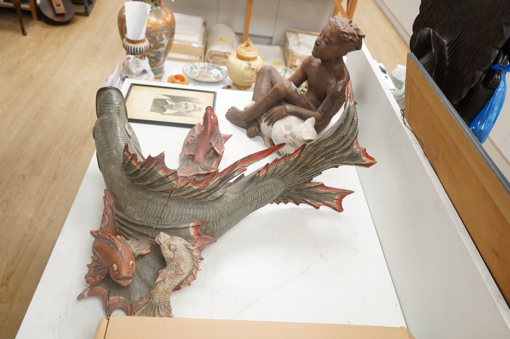 A large carved and painted wood hanging fish